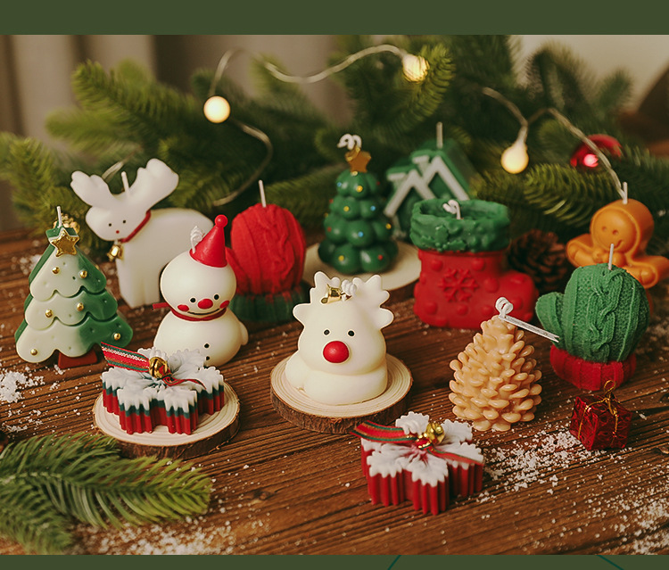 Collection of Christmas shaped candles arranged on a wooden table